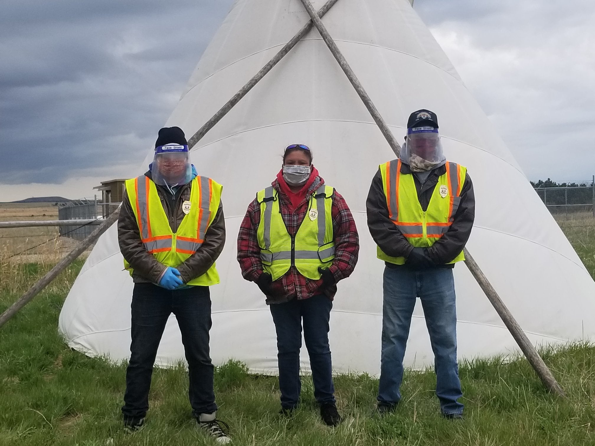 Three Cheyenne River Sioux Tribe checkpoint deputies look safe and strong in reflective safety vests and their PPE image from Protect Native Elders Facebook page