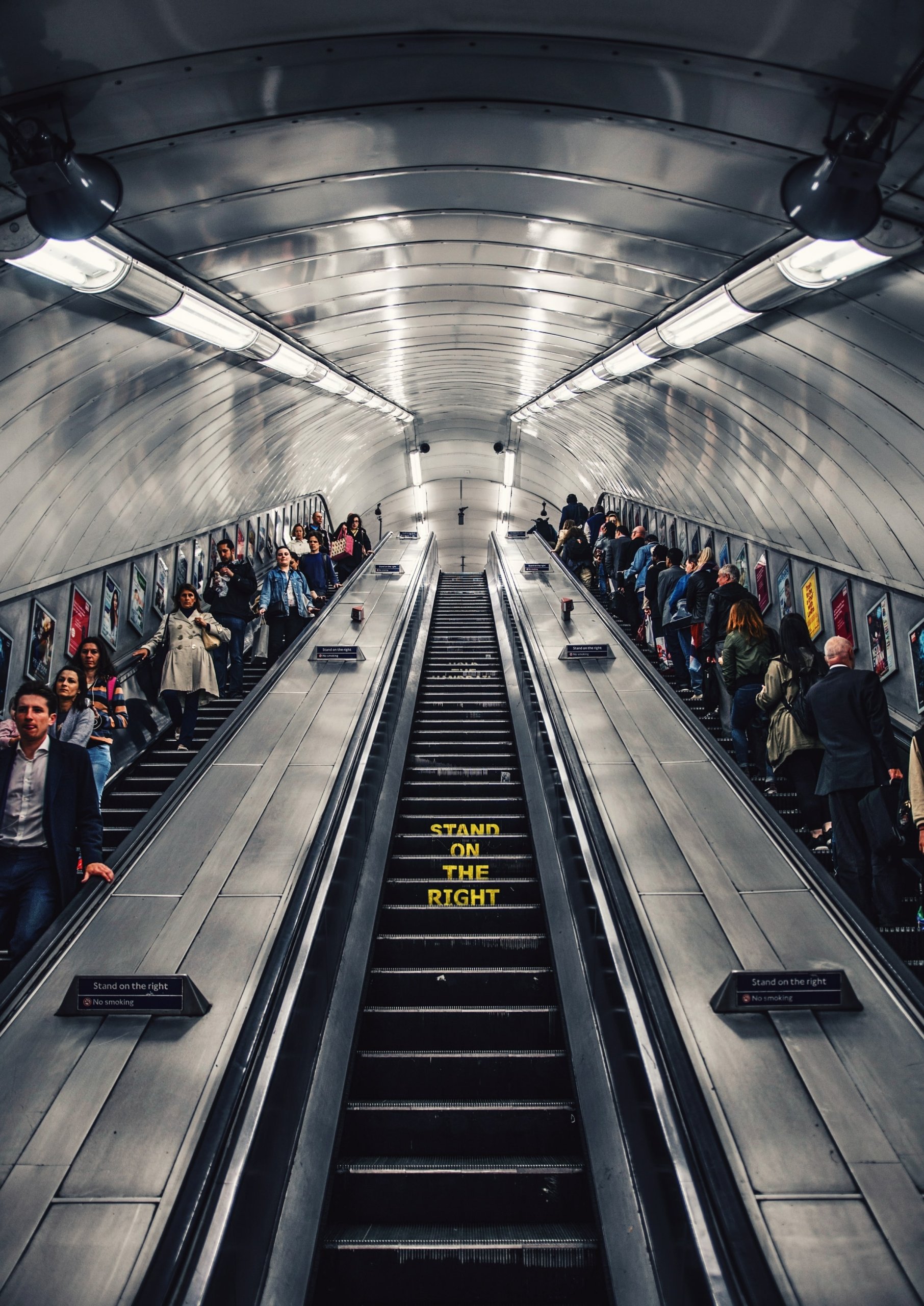 Mental Wellbeing - people riding the escalator in the London Tube