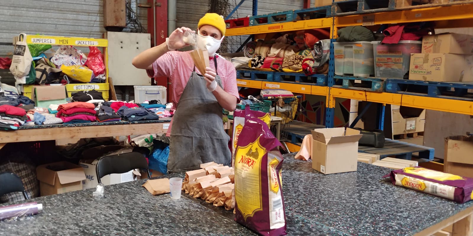 Food provisions Volunteer working at the warehouse at Calais Food Collective wearing a mask due to pandemic