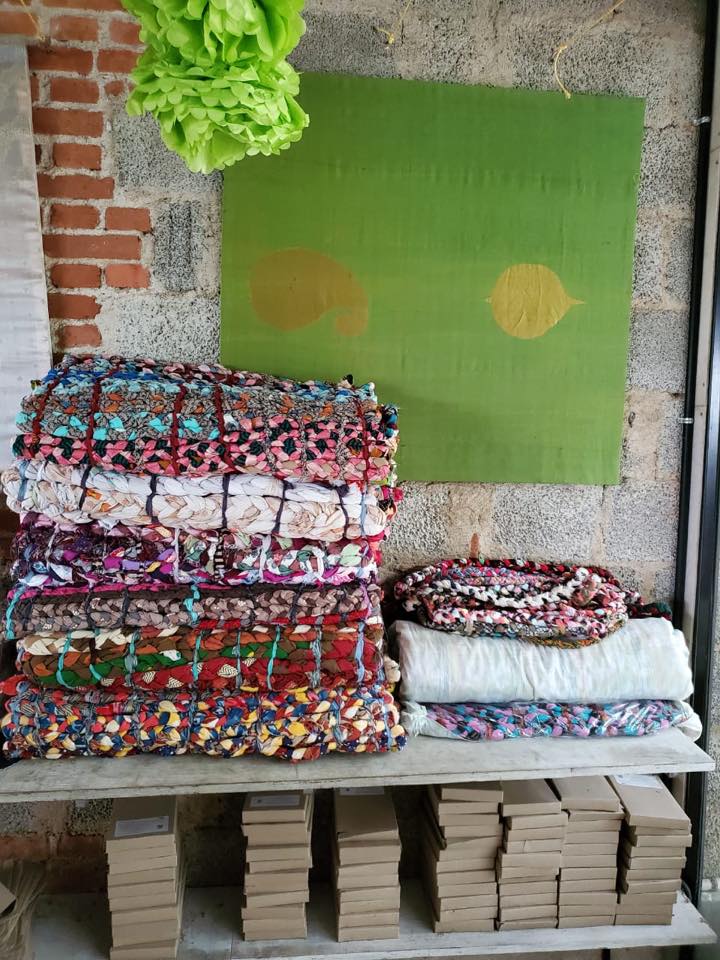 Multicolored cloth braided Shayya bedrolls stacked on a shelf