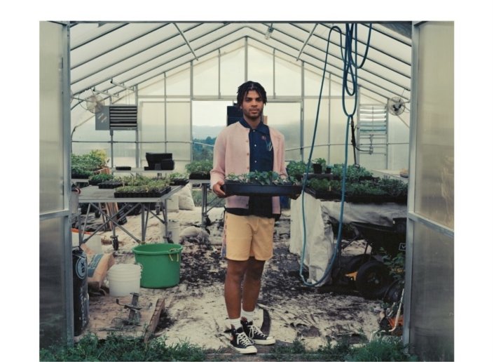 Sky high farm collection look book, man standing in a greenhouse