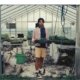 Sky high farm collection look book, man standing in a greenhouse