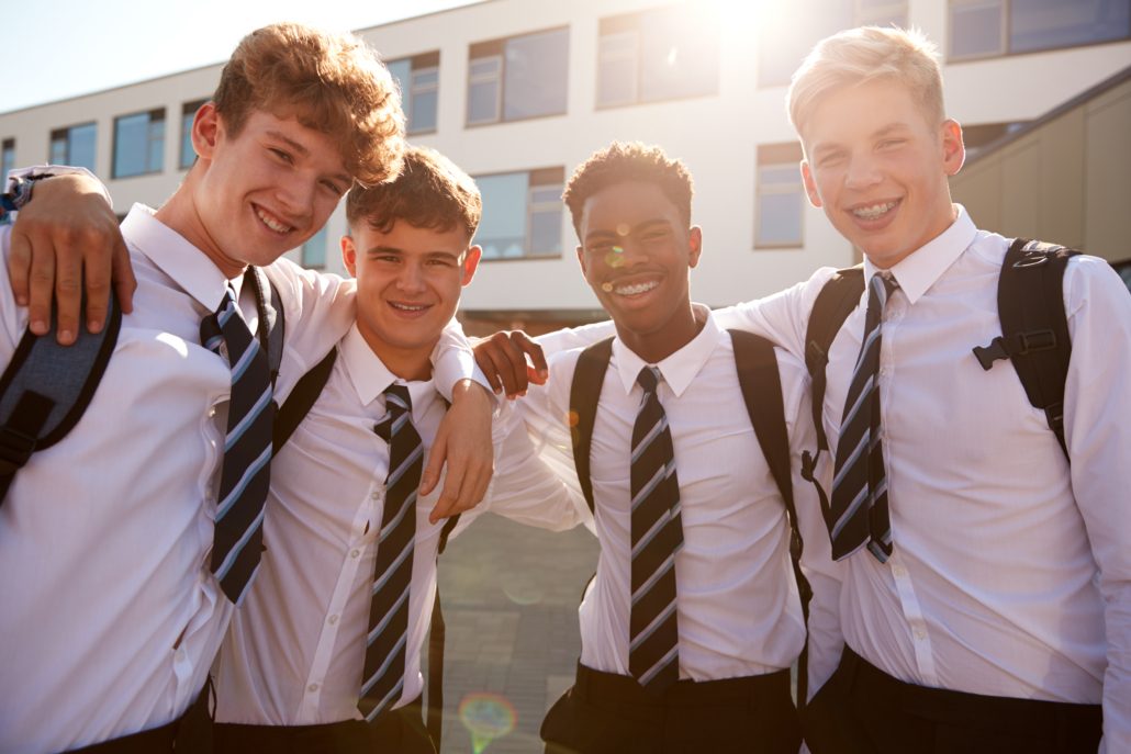 three male adolescents in their school uniform