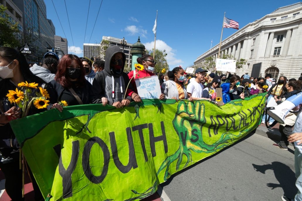 Youth Vs. Apocalypse banner at a protest